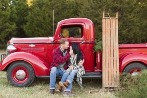 vintage_christmas_engagement-couple_sitting_car_sled