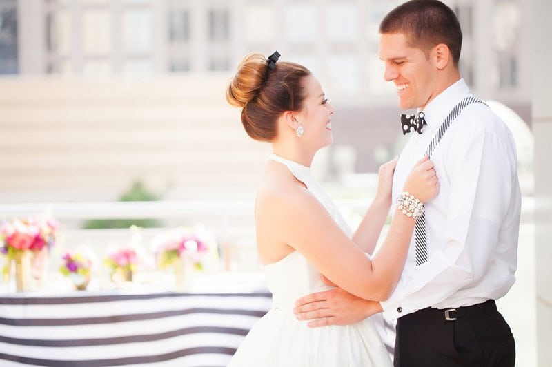 Kate_Spade_Wedding_Yes-Please-Bride_Holding_Grooms_Suspenders