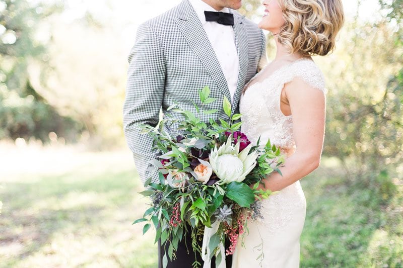 Modern_Ranch_Wedding_to_Remember_AllisonJeffersWeddingPhotography_couple_holding_flowers