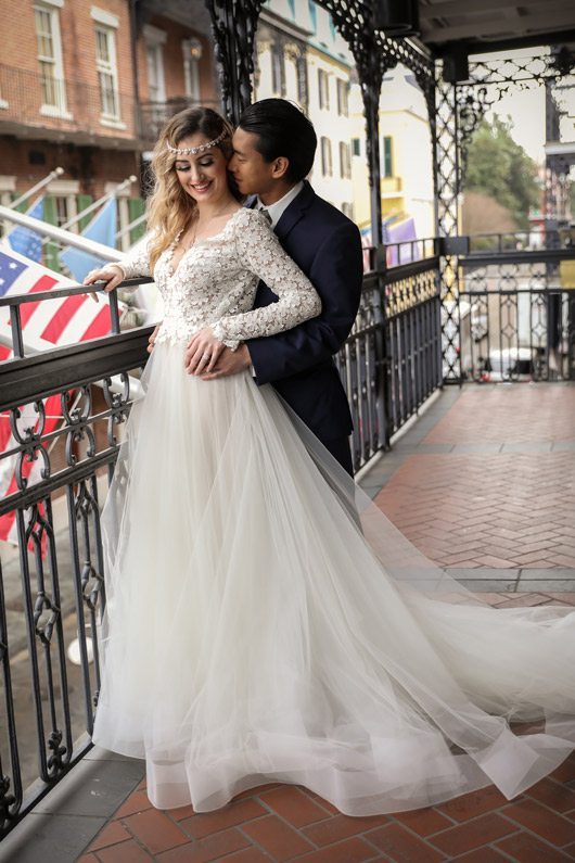 Trendy_Long_Sleeve_Tara_Keely_Wedding_Gown-bride_and_groom_on_balcony