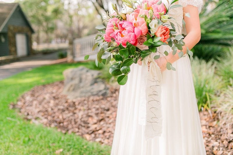 Dusty_Blue_Wedding-bride_holding_flowers