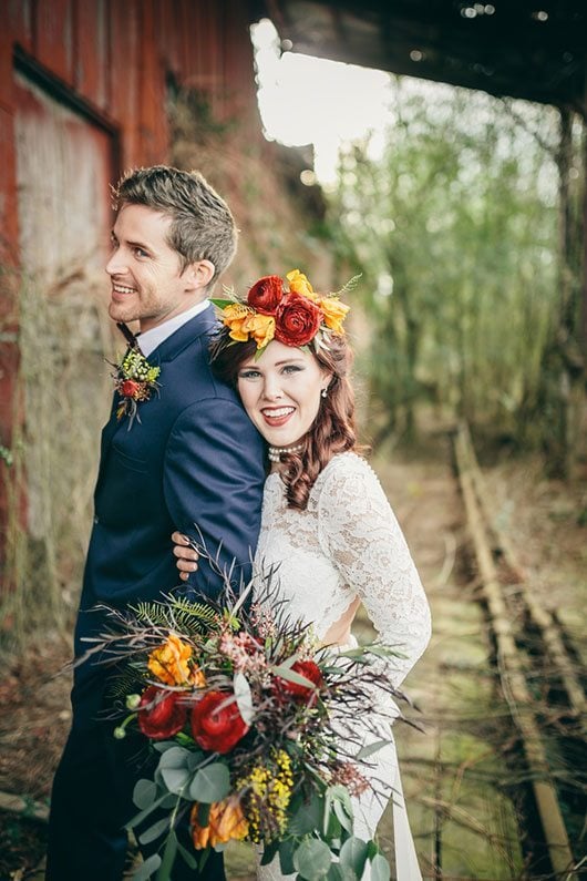 Industrial_Warehouse_Shoot-bride_and_groom_laughing_at_railroad_track