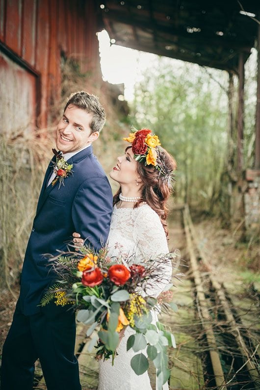 Industrial_Warehouse_Shoot-bride_and_groom_smiling_on_railroad_track