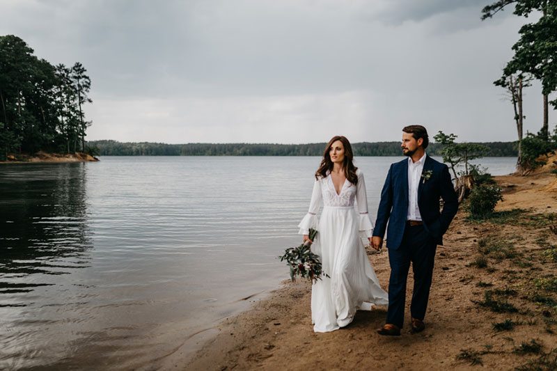 Maroon_Inspiration-bride_and_groom_walking_on_sand