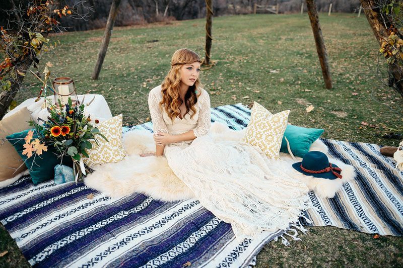 Outdoor_wedding-bride_laying_on_colorful_blanket