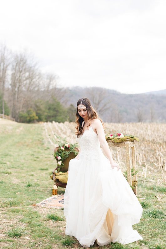 Outdoor_wedding_with_pops_of_color-bride_holding_gown