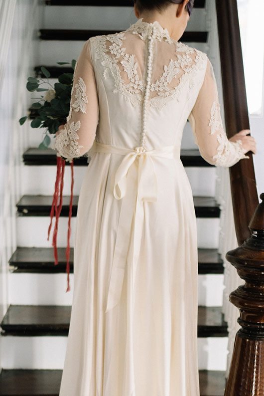 Vintage_Winter_Bridal-bride_walking_up_stairs_back_of_dress