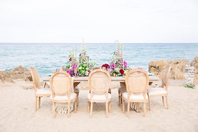 Chic_Coastal_Wedding-wide_view_of_table_with_chairs