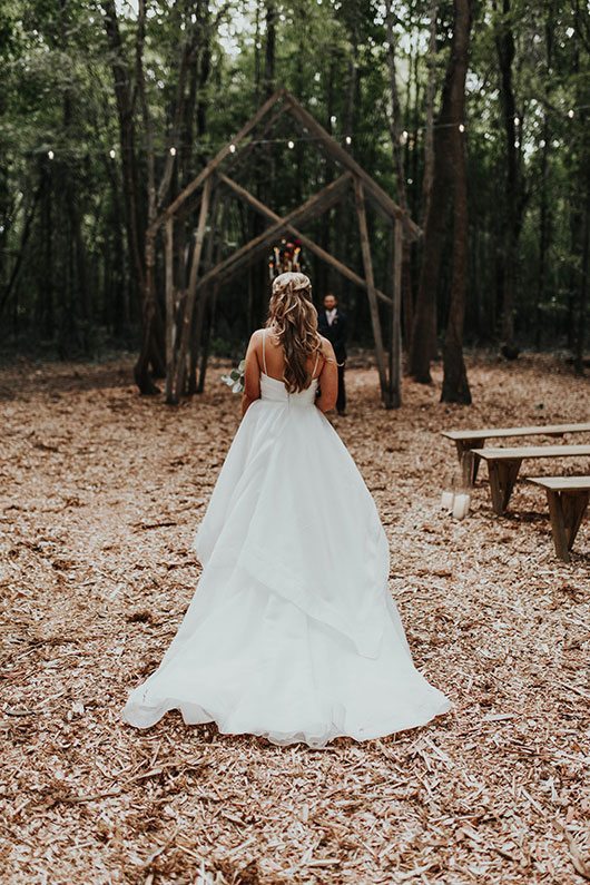 Enchanted_Forrest_Wedding-back_of_bride_walking_down_aisle