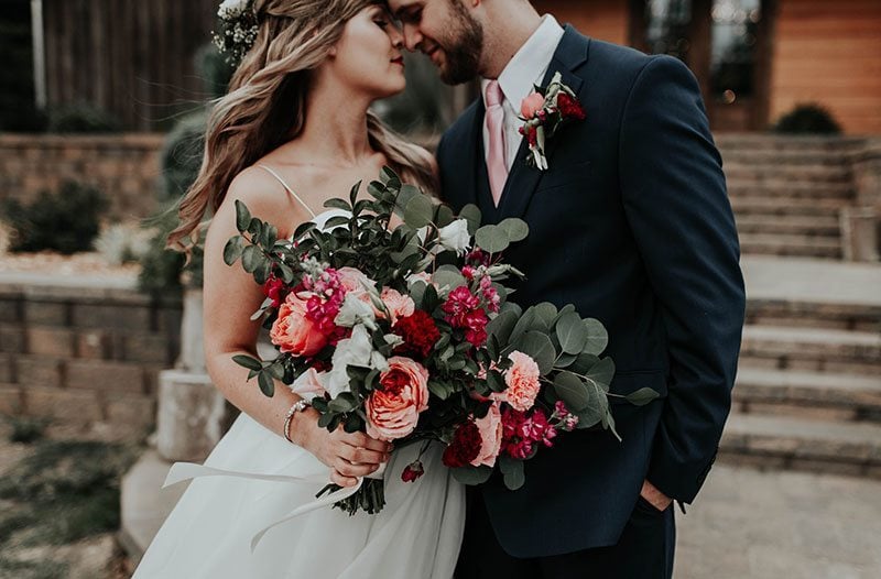 Enchanted_Forrest_Wedding-bride_holding_flowers_with_groom