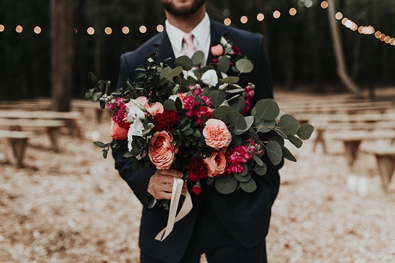 Enchanted_Forrest_Wedding-groom_holding_flowers_closeup