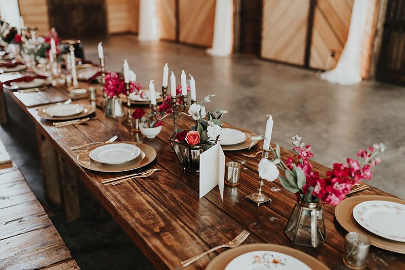 Enchanted_Forrest_Wedding-wooden_table_with_flowers_and_china