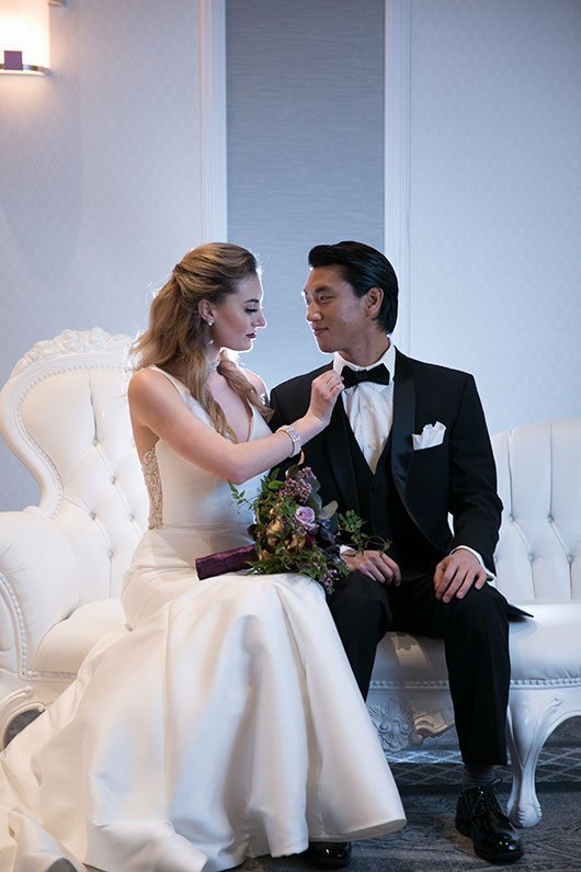 Fashion Mori Lee Bride And Groom Sitting On Couch