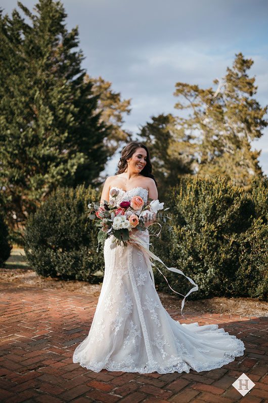 Modern_rustic_wedding-bride_holding_flowers_and_smiling