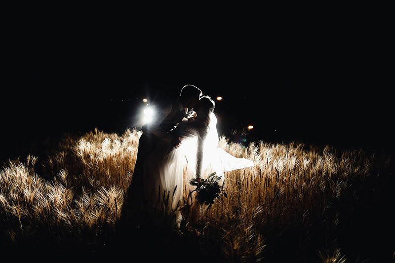 Bountiful Wheat Harvest Bride And Groom Kissing In Headlights