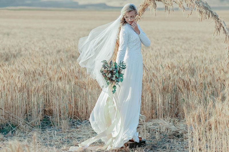 Bountiful Wheat Harvest Bride Holding Flowers In The Wind