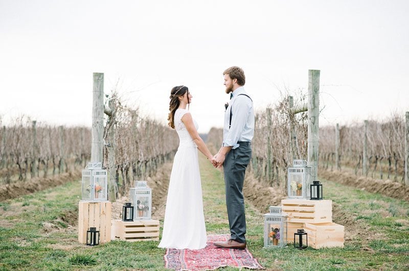 Modern Boho Bride And Groom Holding Hands In Vineyard