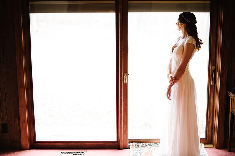 Modern Boho Bride Standing By Window