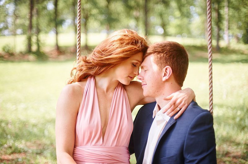 Pink Wedding Bride And Groom Sitting On Swing