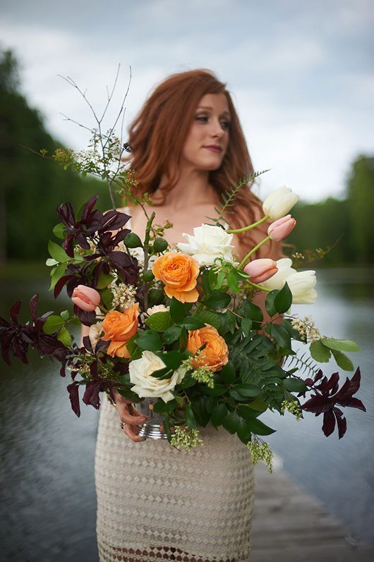 Pink Wedding Bride Holding Flowers By Water