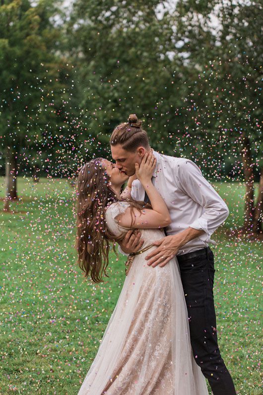 Rain Over Atlanta Bride And Groom Kissing With Confetti