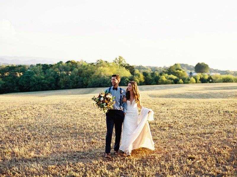 Autumn Bride And Groom Walking In Field