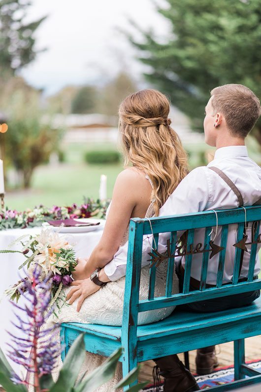 Countryside Bride And Groom Sitting On Blue Bench