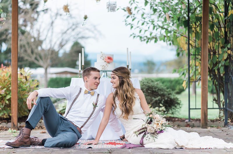 Countryside Bride And Groom Sitting On Ground