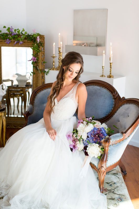 Enchanted Bride Holding Flowers On Couch