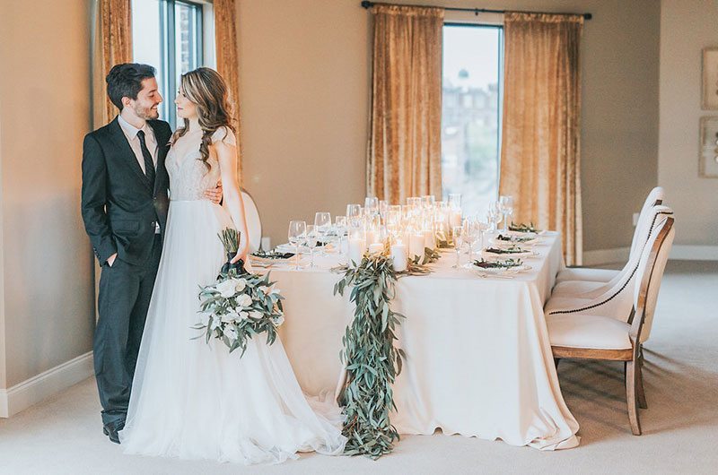 Hotel Bride And Groom Standing By White Table
