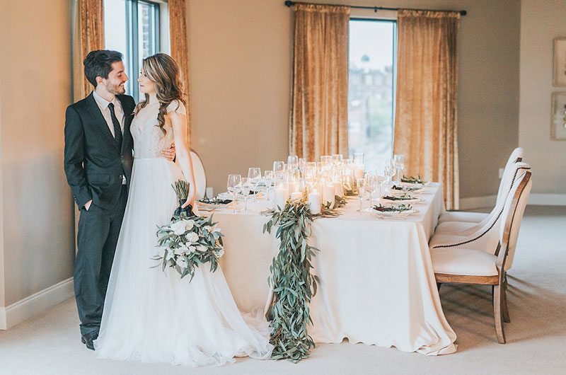 Hotel Bride And Groom Standing By White Table