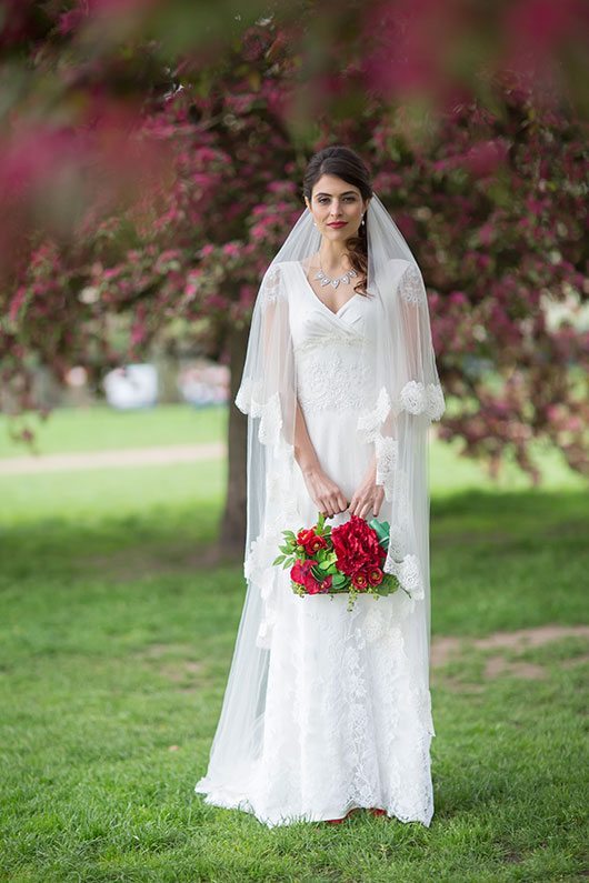 London Bride Holding Flowers In Park