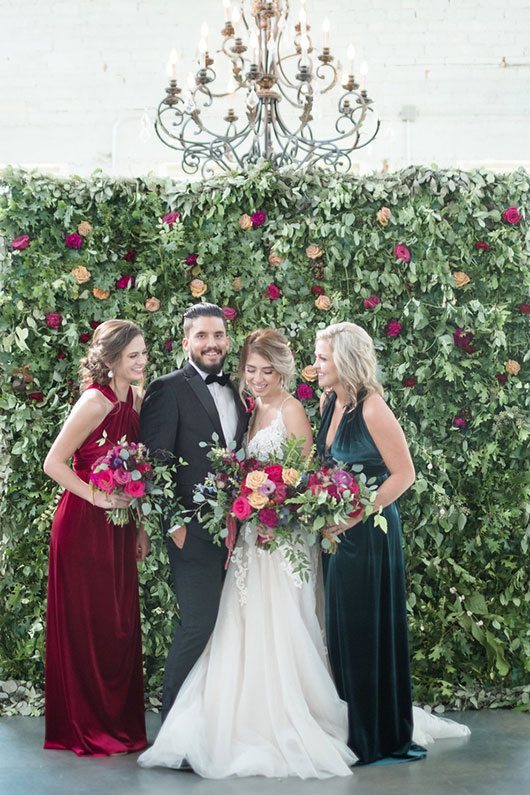 Vintage Copper Bridal Party In Front Of Flower Wall