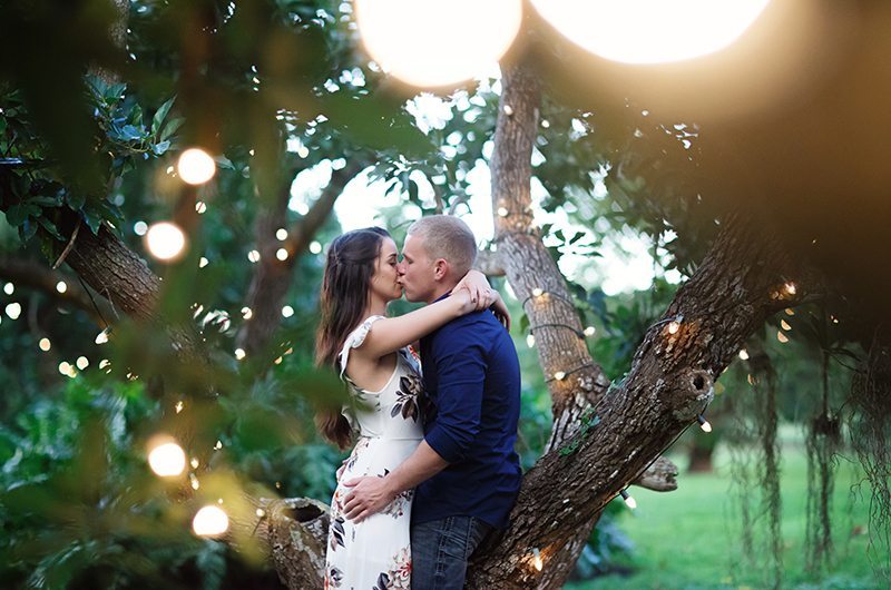 Cozy Country Engagement Session Couple Kissing Under Lights