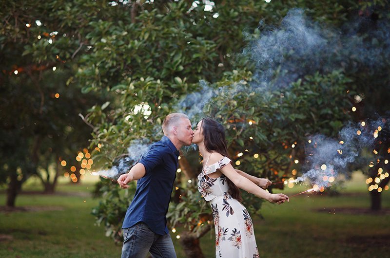 Cozy Country Engagement Session Couple Kissing With Sparklers