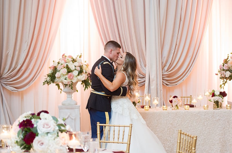 Casey Holmes Reception Kissing Near Table