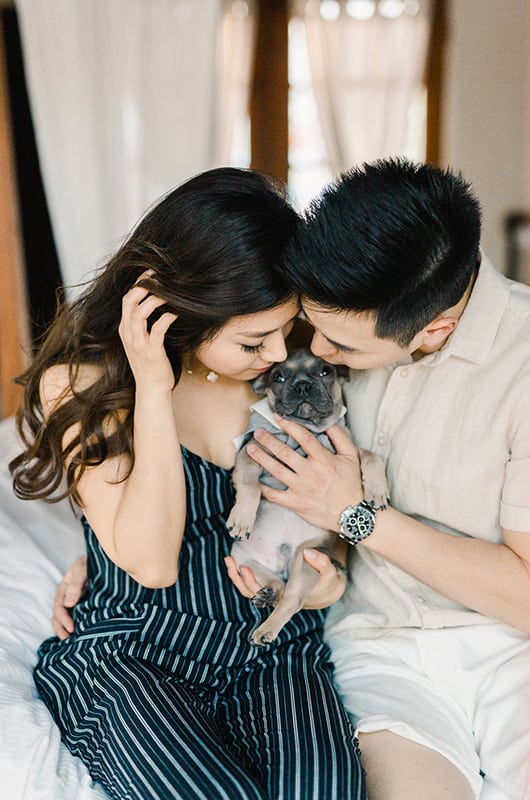 Kim Ye Engagement Portrait Holding Dog In Bed