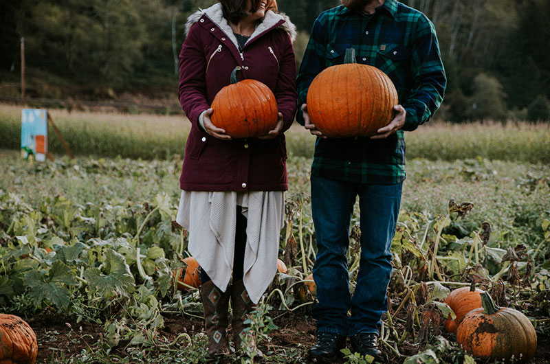 Dreamy Pumpkin Patch Engagement Photoshoot Holding Pumpkins