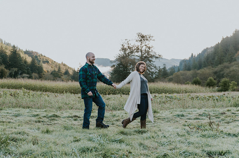 Dreamy Pumpkin Patch Engagement Photoshoot Walking Across Field