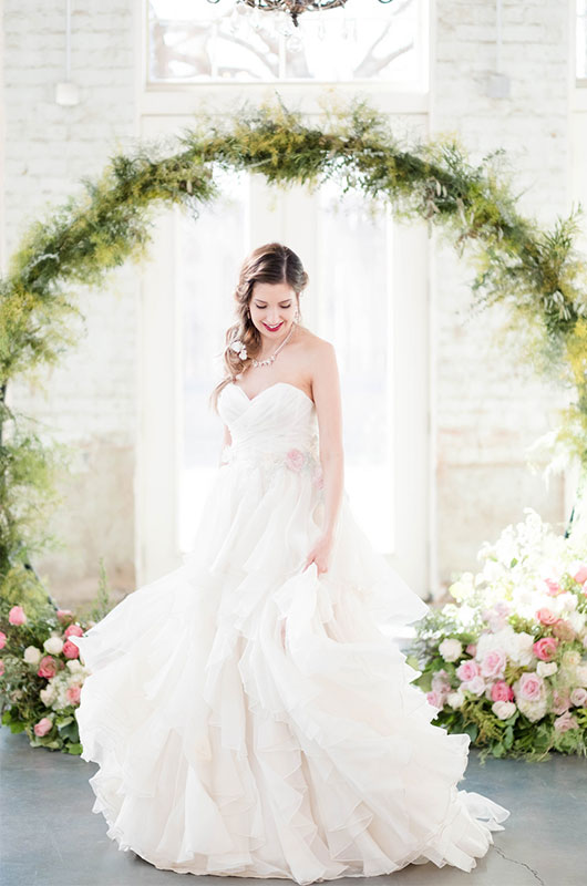 Pastel And Watercolor Styled Shoot Bride In Front Of Arch