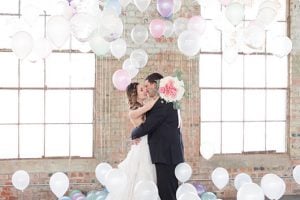 Pastel And Watercolor Styled Shoot Kissing In Balloon Room