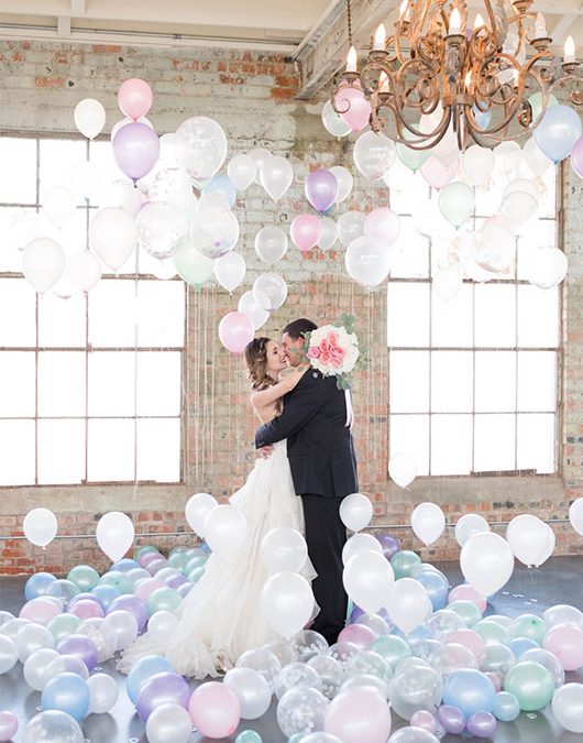 Pastel And Watercolor Styled Shoot Kissing In Balloon Room