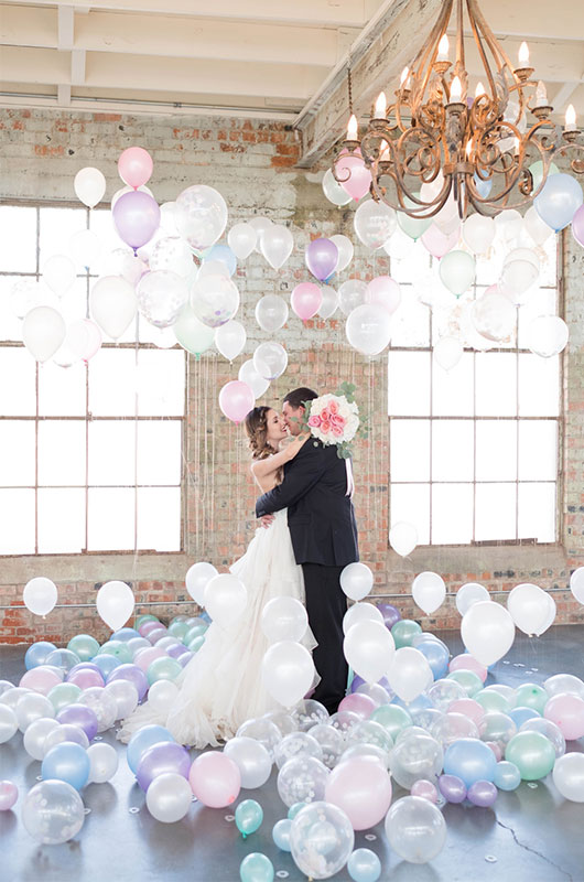 Pastel And Watercolor Styled Shoot Kissing In Balloon Room