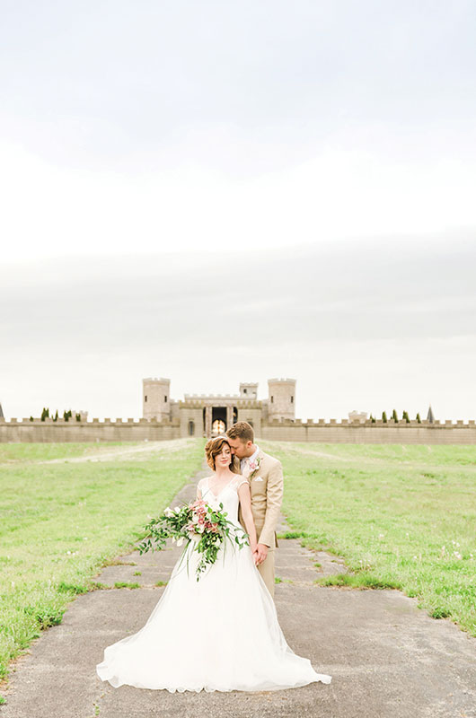 Royally Ever After Couple In Front Of Castle