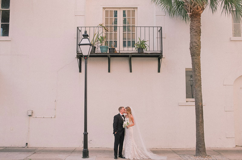 The First Real Weddings At Charlestons Hotel Bennet Make Their Debut Bride Groom In Front Of Wall