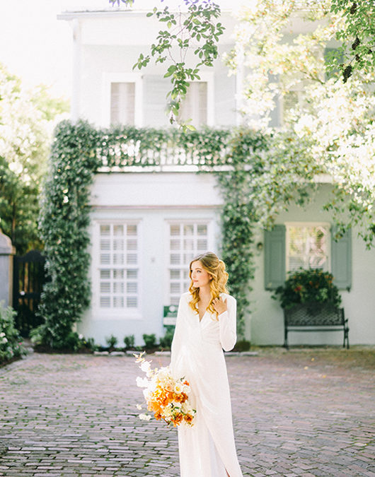 Historic Charleston Bridal Shoot On Rainbow Row Bride With Simple Dress In Front Of House