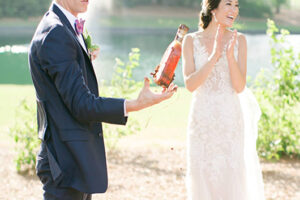 Bridal Couples Bury The Burbon At Pursell Famrs Couple Holding Burbon Bottle