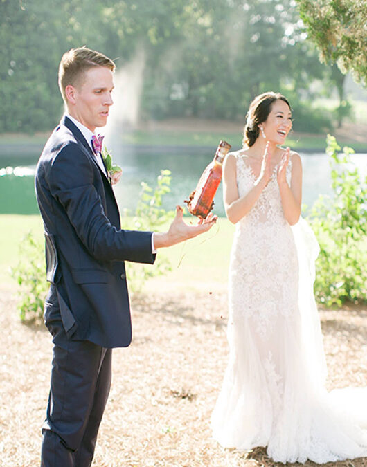 Bridal Couples Bury The Burbon At Pursell Famrs Couple Holding Burbon Bottle