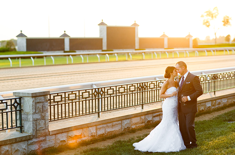 Host Your Wedding In Horse Country At Keeneland Bride And Groom In Front Of Horse Track