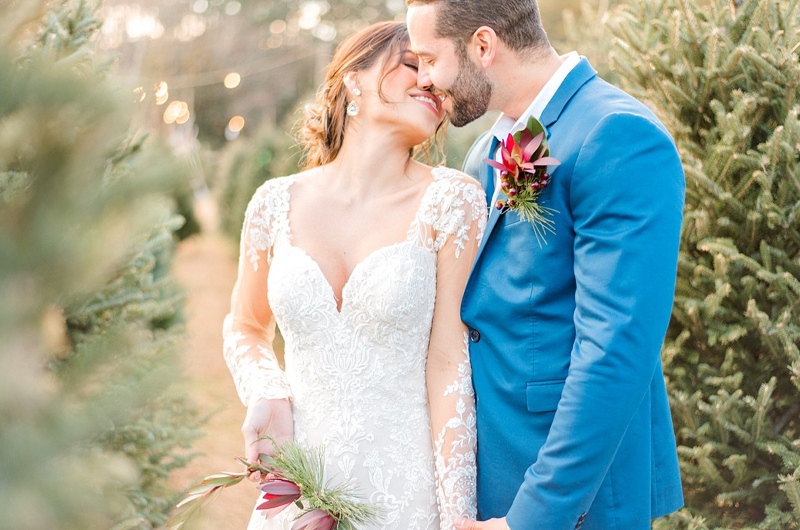 Dreamy Christmas Tree Styled Shoot Bride In Lace Wedding Dress Smiling At Groom